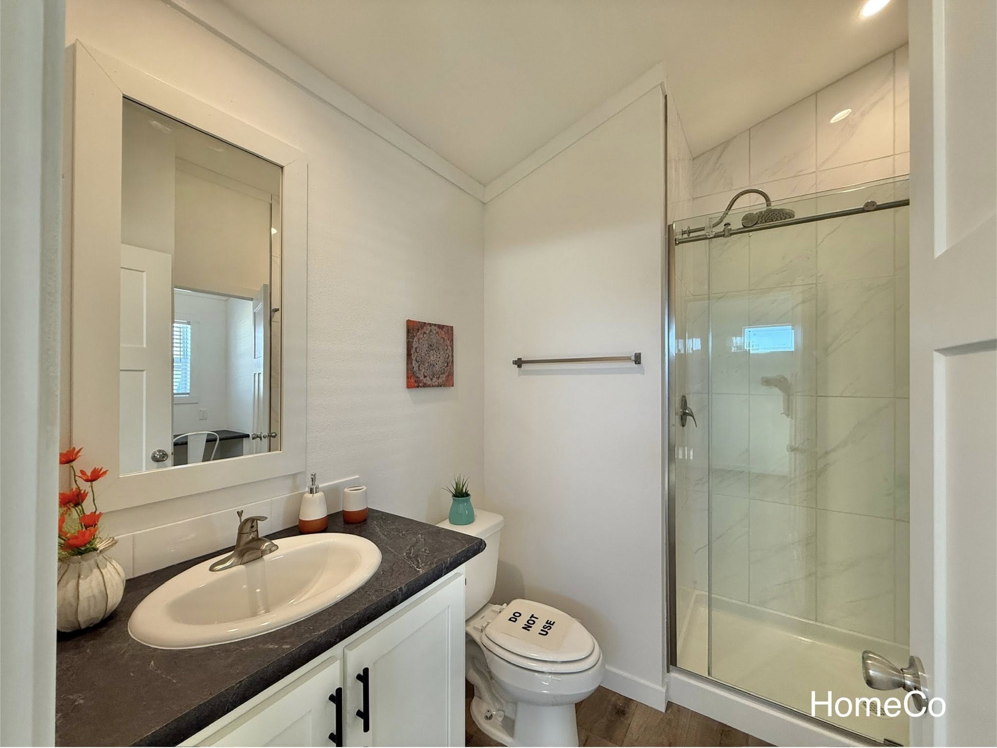 Luxury modular and tiny home collection featuring navy blue and white farmhouse exteriors, gourmet kitchens with quartz waterfall islands, hidden arched pantries, industrial corrugated metal accents, and minimalist lofts with vaulted ceilings and rustic stone fireplaces.