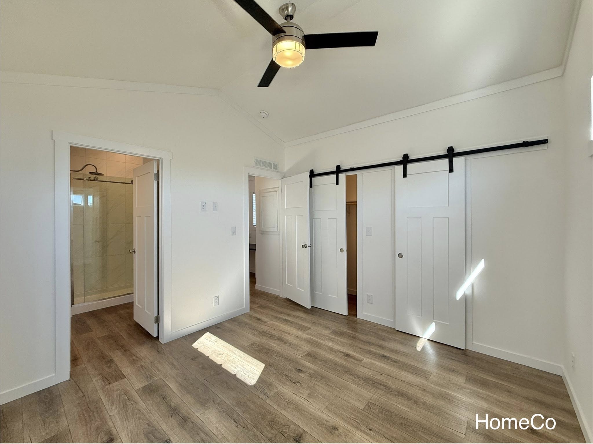 Comprehensive collection of luxury modular and tiny home designs featuring navy blue and white farmhouse exteriors, gourmet kitchens with quartz waterfall islands, hidden arched pantries, and modern-rustic interiors with vaulted ceilings, sliding barn doors, and stone fireplaces.