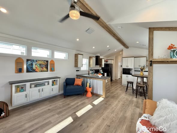 Luxury modern tiny home collection and modular farmhouse interiors featuring open-concept kitchens with quartz waterfall islands, industrial corrugated metal accents, hidden arched pantries, and minimalist lofts with white shaker cabinetry.