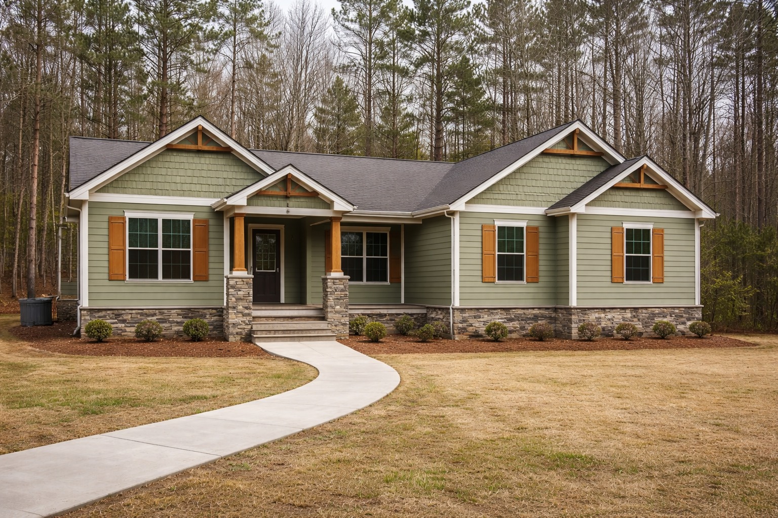 A single-story green house with brown shutters and stone accents is surrounded by a neat lawn and trees. A curved path leads to the front porch, creating a welcoming atmosphere.