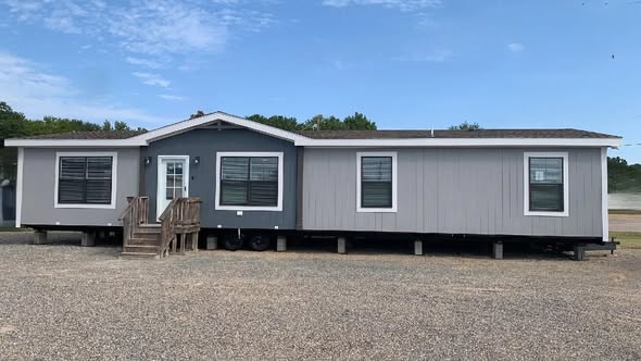 Luxury manufactured home collection and 819 SQ FT farmhouse floor plan featuring open-concept kitchens with industrial metal accents, hidden arched pantries, stone fireplaces, and modern tiny house lofts with vaulted ceilings and sliding barn doors.