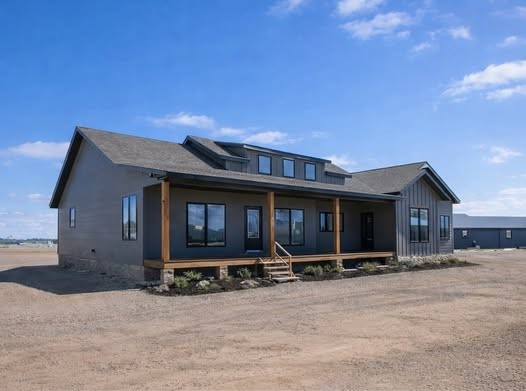 This extensive image gallery showcases various luxury models, including tiny homes, park models, and spacious manufactured residences that blend a modern farmhouse aesthetic with high-end functional design. The exteriors are characterized by high-contrast color schemes, featuring white or cream board-and-batten siding paired with dark charcoal gables, gabled front porches with black or white support pillars, and durable metal roofing. Inside, the living areas emphasize an upscale, open-concept lifestyle with vaulted ceilings—some featuring natural wood planks or exposed beams—complemented by wide-plank wood-look flooring and crisp shiplap or neutral-toned walls. Gourmet kitchens are designed for high functionality, offering cabinetry in finishes ranging from light natural oak to elegant black, paired with marble-patterned or wood-block countertops, stainless steel farmhouse sinks, and large center islands with modern pendant lighting. Additional luxury elements include integrated booth seating, transom windows for maximum natural light, industrial-style ceiling fans, and spacious bedrooms with neutral carpeting. Contemporary bathrooms complete the homes with white vanities, black hardware, and choices of walk-in showers or large soaking tubs.