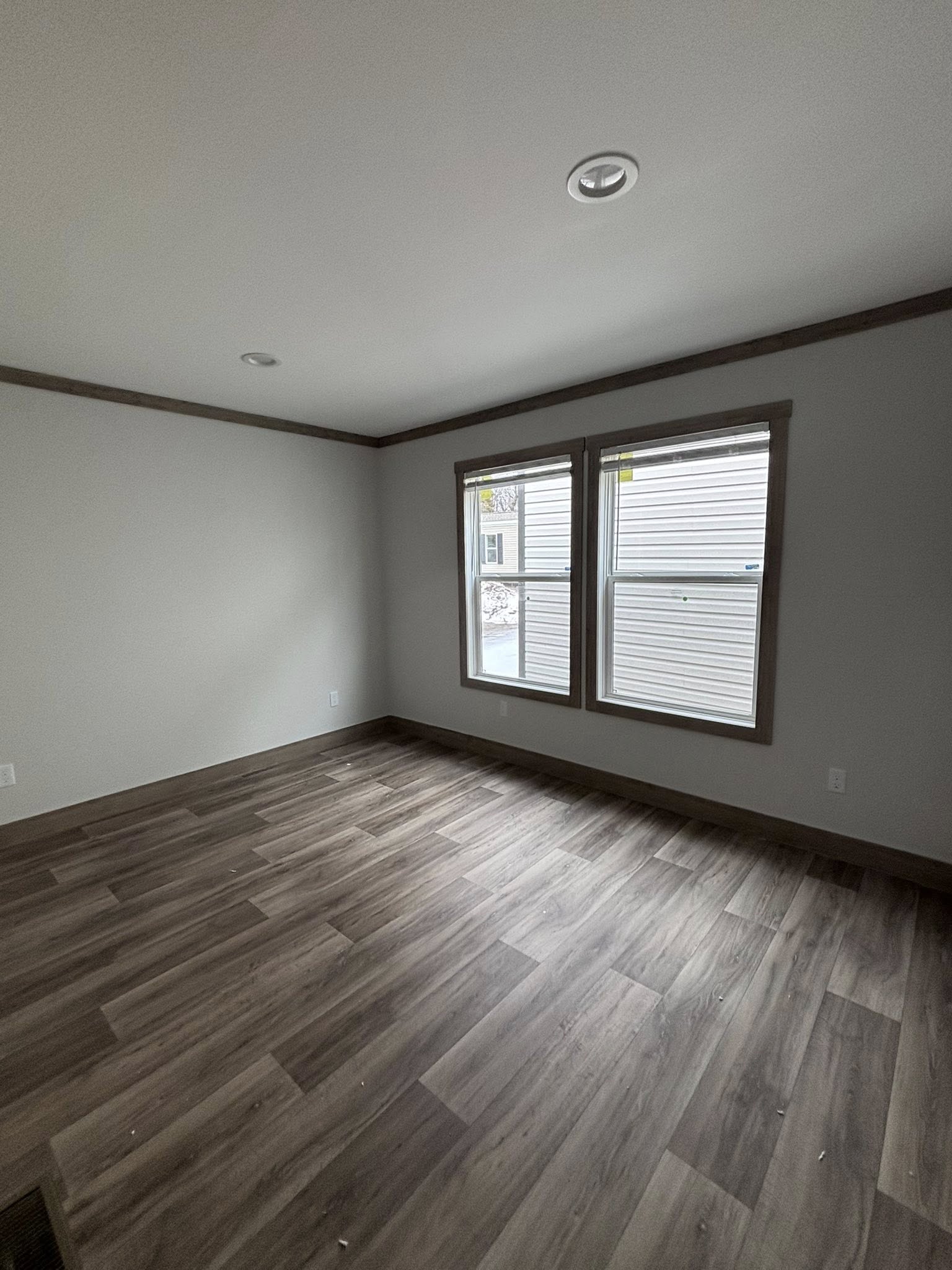 ALT TEXT
This extensive image gallery features the "Boujee XL" series of luxury tiny homes, park models, and manufactured homes, showcasing a refined modern farmhouse aesthetic through both exterior and interior designs. The exteriors highlight a variety of sophisticated color palettes, including crisp white and cream board-and-batten siding accented by charcoal gables, spacious gabled front porches with black or white pillars, and durable metal roofs in white or dark grey.

The interior living areas emphasize open-concept luxury with vaulted ceilings—some featuring natural wood planks, exposed beams, or industrial-style ceiling fans—complemented by wide-plank wood-look flooring and crisp shiplap or neutral-toned walls. Gourmet kitchens are designed for high functionality, featuring cabinetry in finishes ranging from light natural oak to elegant black, white, or wood-grain tones, paired with marble-patterned or distressed wood countertops, stainless steel farmhouse sinks, and large center islands with modern pendant lighting.

Functional luxury is further integrated through built-in booth seating, transom windows that flood spaces with natural light, and private bedrooms with neutral carpeting and modern trim. Contemporary bathrooms feature white vanities, black hardware, and integrated tub-and-shower units.