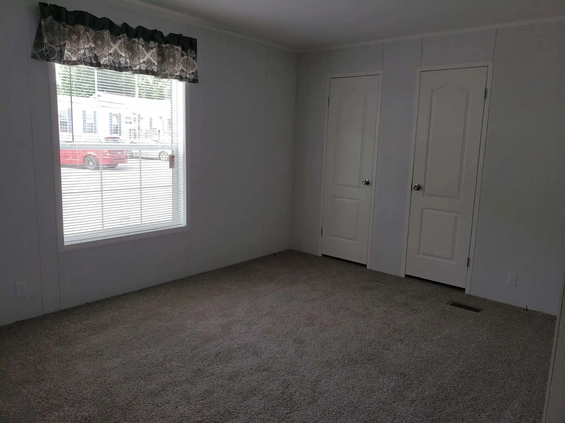 High-end residential showcase featuring a diverse collection of modern manufactured homes and park models, including the expansive "The Boujee XL" aesthetic. Exterior Architectural Styles: Highlights include classic white board-and-batten tiny homes with grand pillared front porches and black metal railings. A standout model features a dark charcoal exterior with a copper-tone metal roof, natural cedar wood accents, and a large wrap-around wooden deck. Designs vary from single-level double-wides on gravel lots to compact, trailer-mounted tiny homes with high-pitched gabled roofs. Interior Living & Custom Design: Open-concept interiors are defined by high-fidelity finishes, including vaulted ceilings with rustic dark wood beams and white shiplap walls. Living spaces showcase a "modern boujee" style with neutral-toned sofas, integrated electric fireplaces with white mantels, and lofted sleeping quarters featuring black metal balustrades. Gourmet Kitchens: The collection features diverse kitchen layouts, from rustic wood-cabin style kitchens with dark marble-look countertops and stainless steel refrigerators to high-end modern designs. Premium features include oversized kitchen islands in statement colors like teal and charcoal, white farmhouse cabinetry, recessed lighting, and elegant pendant chandeliers over dining areas with dark wood-look flooring. Spa-Inspired Bathrooms: Bathrooms emphasize modern luxury with walk-in tile showers featuring black matte hardware, marble-look surrounds, and contemporary vanities with ample storage. This gallery represents the pinnacle of "boujee" manufactured living, combining versatile 4-to-5 bedroom layouts with sophisticated, modern farmhouse aesthetics.