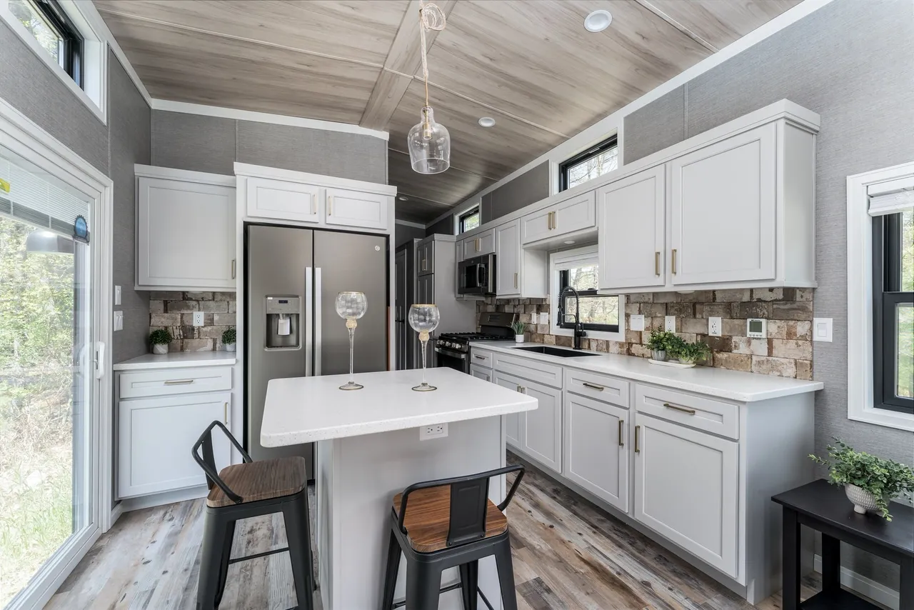 High-ranking SEO-optimized gallery showcasing luxury tiny houses and modern manufactured homes, featuring a navy blue park model with a spacious screened porch and white trim, a light blue beach cottage with a vaulted white shiplap interior and gourmet kitchen, and a large white ranch-style modular home with brick skirting; the collection highlights premium mobile living, innovative small-space architectural design, and contemporary interior decor featuring vaulted wood-plank ceilings, stainless steel appliances, and stylish living areas for maximum search visibility.