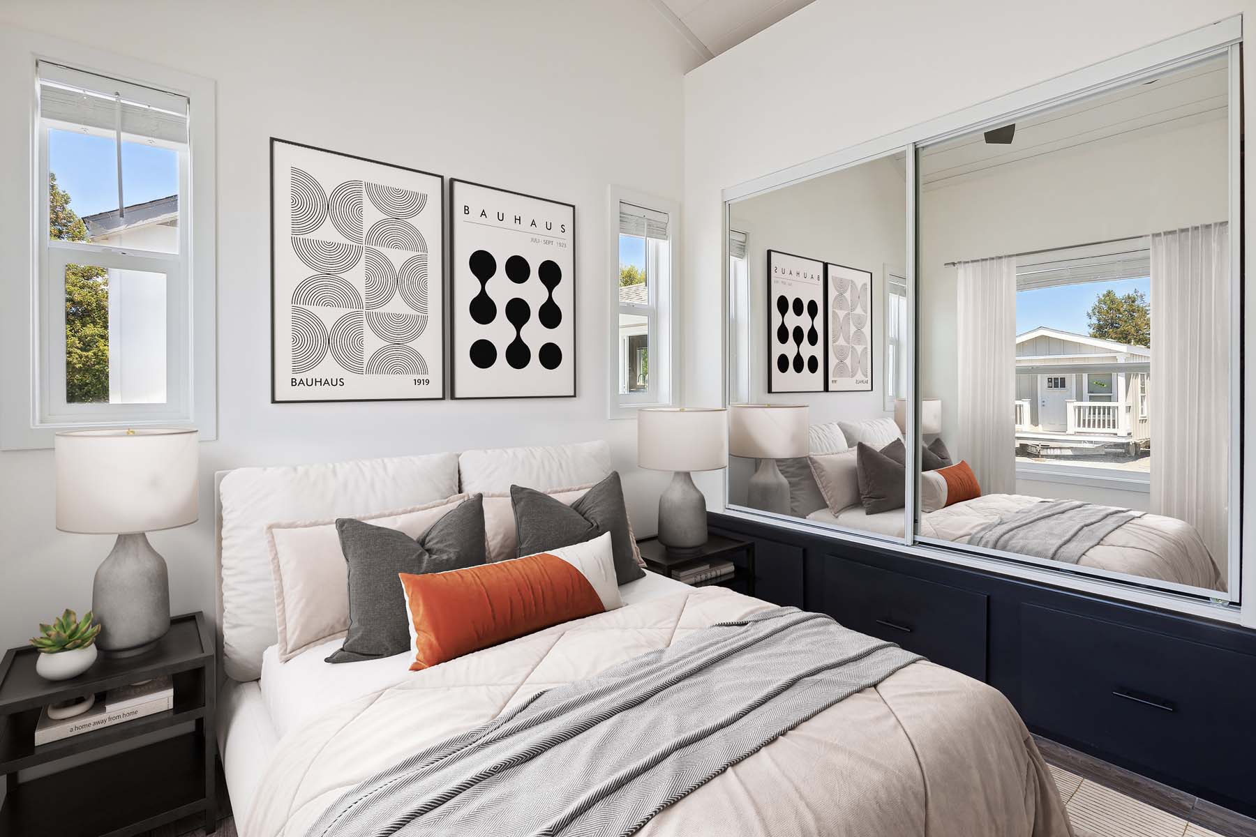 Luxury modern tiny house interior by Recreational Resort Cottages featuring a bright open-concept kitchen with white shaker cabinets, white quartz countertops, and a rustic wood-plank ceiling with recessed lighting. The space is optimized for small-scale living with a mobile butcher block kitchen island, a vibrant blue refrigerator, stainless steel appliances, and a loft sleeping area with black metal railings accessible by a staircase, showcasing a contemporary park model cottage design perfect for high-end mobile living and professional vacation rental marketing.