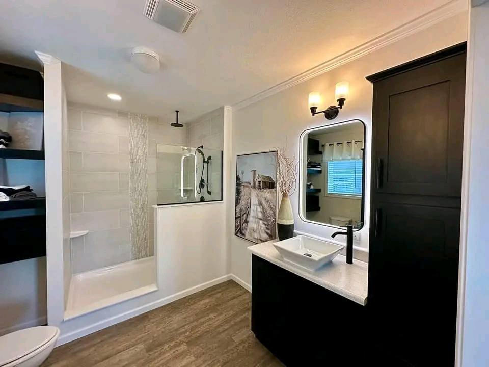 High-ranking SEO-optimized gallery of luxury tiny houses and modern manufactured homes, featuring a navy blue park model with a screened porch, a light blue beach cottage with a vaulted white shiplap interior and gourmet kitchen, and a large white ranch-style modular home with brick skirting; the collection highlights premium mobile living, innovative small-space architectural design, and contemporary interior decor featuring vaulted ceilings, LED-accented tray ceilings, stainless steel appliances, and stylish living areas for maximum search visibility.