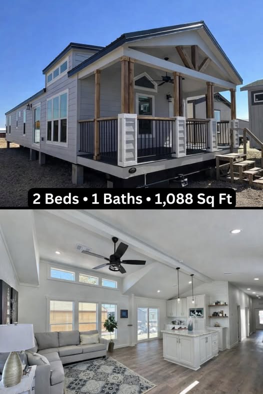 Modern luxury 1,088 square foot modular home featuring a spacious covered front porch with natural wood pillars and a gabled roof with a decorative timber truss, paired with an airy open-concept interior showcasing a vaulted ceiling, recessed lighting, and a white kitchen with a marble-top island. The contemporary architectural design includes energy-efficient clerestory windows, high-end wide-plank flooring, and a sleek grey sectional sofa in a bright living area, offering a sophisticated and space-efficient floor plan for premium prefab living.