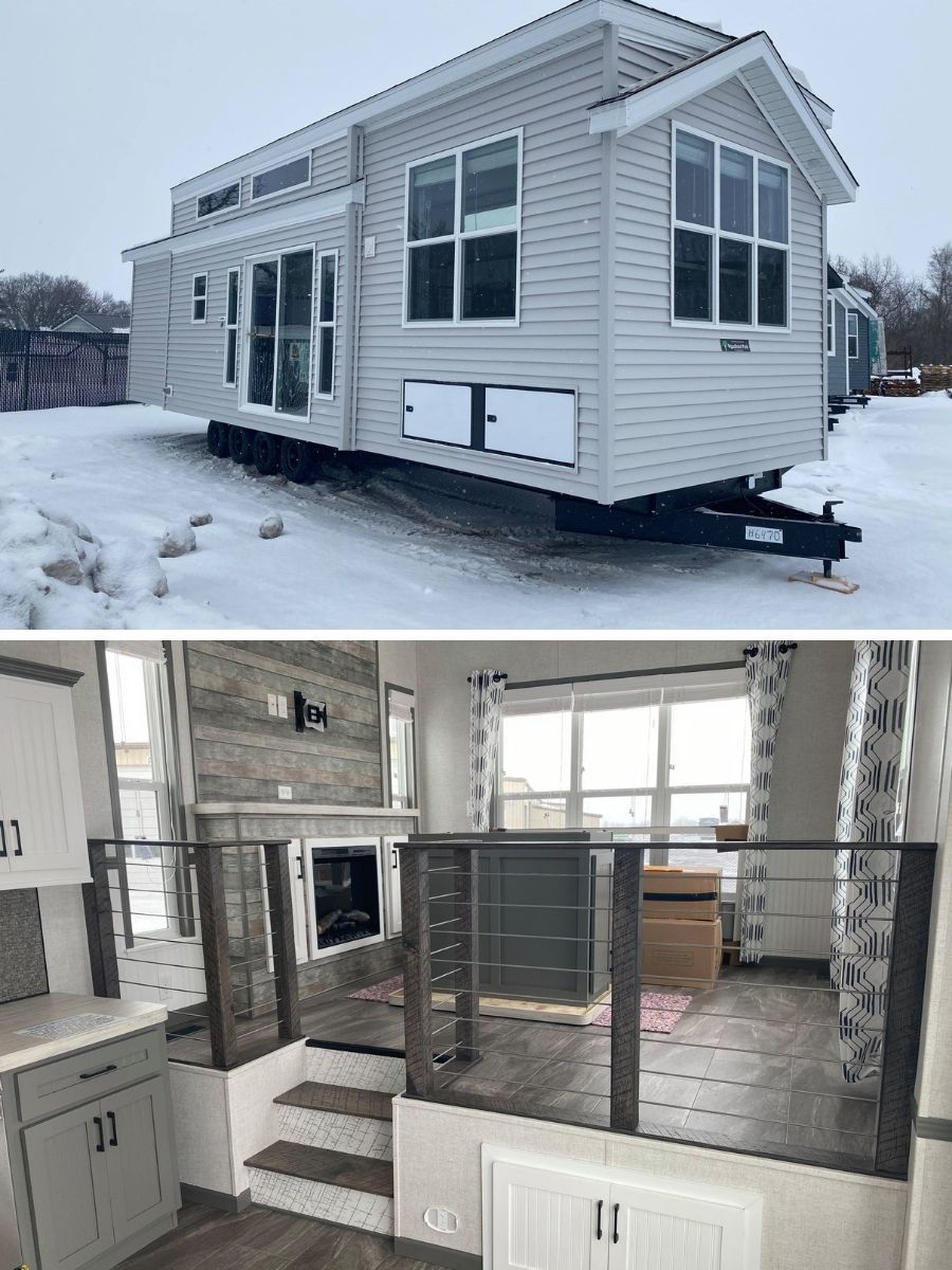 SEO-optimized alt text for a high-ranking modern tiny home or luxury park model featuring a professional light gray vinyl siding exterior with crisp white trim and a gabled roofline; the professional composite view showcases the durable architectural exterior situated in a snowy landscape alongside a sophisticated split-level interior featuring a rustic stone-veneer fireplace, contemporary gray cabinetry, and a stylish loft or raised living area with modern cable railings and large windows, perfectly highlighting premium small-space floor plans, creative modular home layouts, and high-end residential mobile living finishes for maximum search engine visibility and ranking.

Would you like me to focus on the fireplace details or the exterior storage features for the next one?