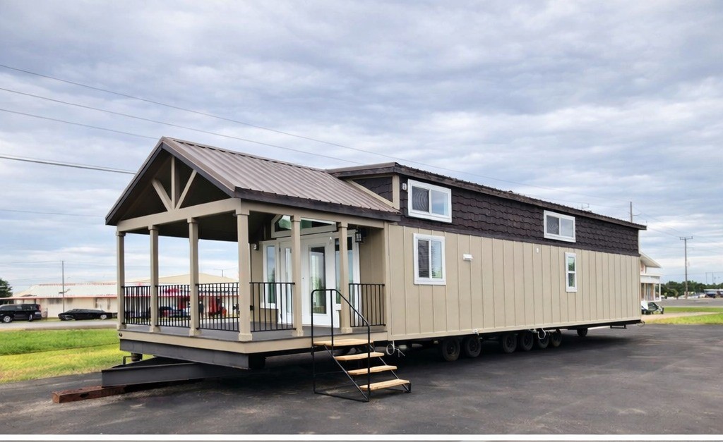 Modern luxury tiny home for sale featuring a dual-view showcase of a sophisticated tan and chocolate brown board and batten exterior with a large gabled front porch, alongside a bright open-concept interior including a grey tufted sofa, a rustic kitchen island with a reclaimed wood countertop, and a space-saving loft with black metal safety railings under a vaulted white shiplap ceiling for a high-end move-in ready turn-key residential design.