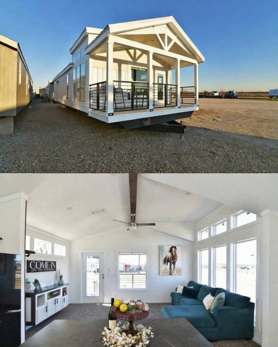 SEO-optimized alt text for a high-ranking luxury custom park model tiny home interior featuring a professional modern living area with a bright, open-concept floor plan; the architectural view showcases a spacious vaulted ceiling with a sleek dark wood beam and central ceiling fan, a comfortable teal velvet sectional sofa, and premium oversized white-framed windows that offer expansive views and abundant natural light, complemented by a chic white media console, horse-themed wall art, and plush neutral carpeting, perfectly highlighting upscale small-space living designs, luxury prefab home interior finishes, and high-end residential mobile home lifestyle solutions for maximum search engine visibility and ranking.