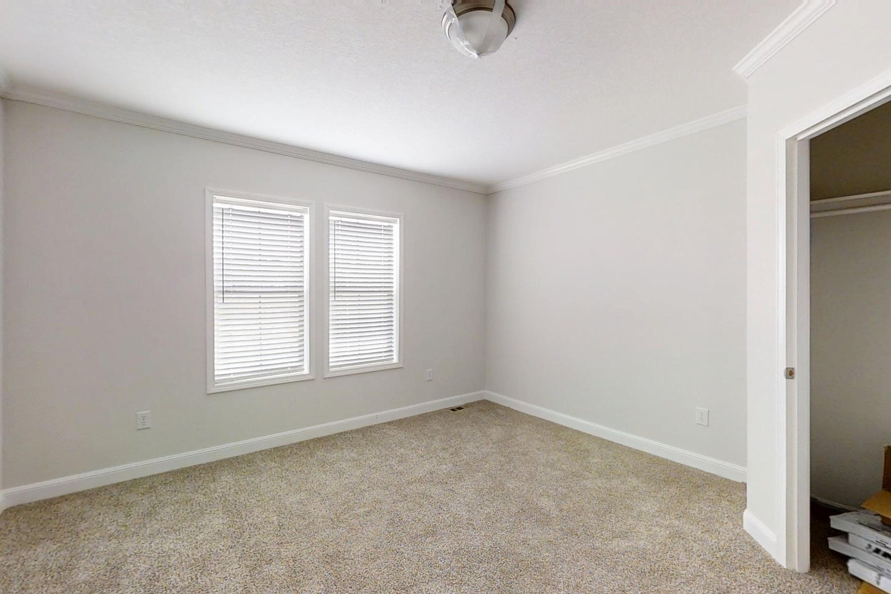Modern transitional kitchen interior featuring white shaker cabinets, premium grey marble-style countertops, and a large stainless steel farmhouse sink under a bright window, complemented by a spacious kitchen island with rustic wood barstools, dark wood ceiling beams, and high-end stainless steel appliances on light oak hardwood flooring for a luxury home renovation and open-concept design inspiration