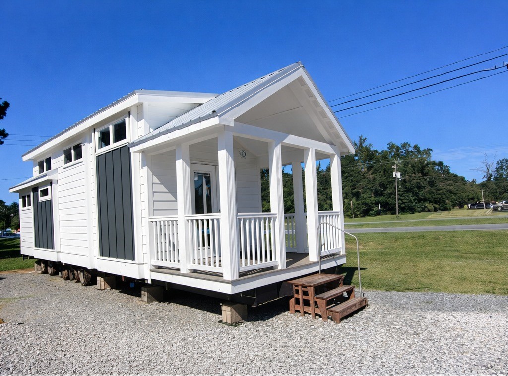 High-ranking SEO-optimized gallery of luxury tiny homes and modern manufactured houses, featuring a sleek white park model with a spacious gabled front porch, a navy blue cottage with natural wood accents, and high-end interior designs including a gourmet kitchen with white shaker cabinets and stainless steel appliances, a cozy living room with a vaulted wood-plank ceiling and stone fireplace, and a spa-like bathroom with a custom tiled walk-in shower and matte black fixtures; the collection highlights premium mobile living, innovative small-space architectural design, and contemporary home decor for maximum search visibility.