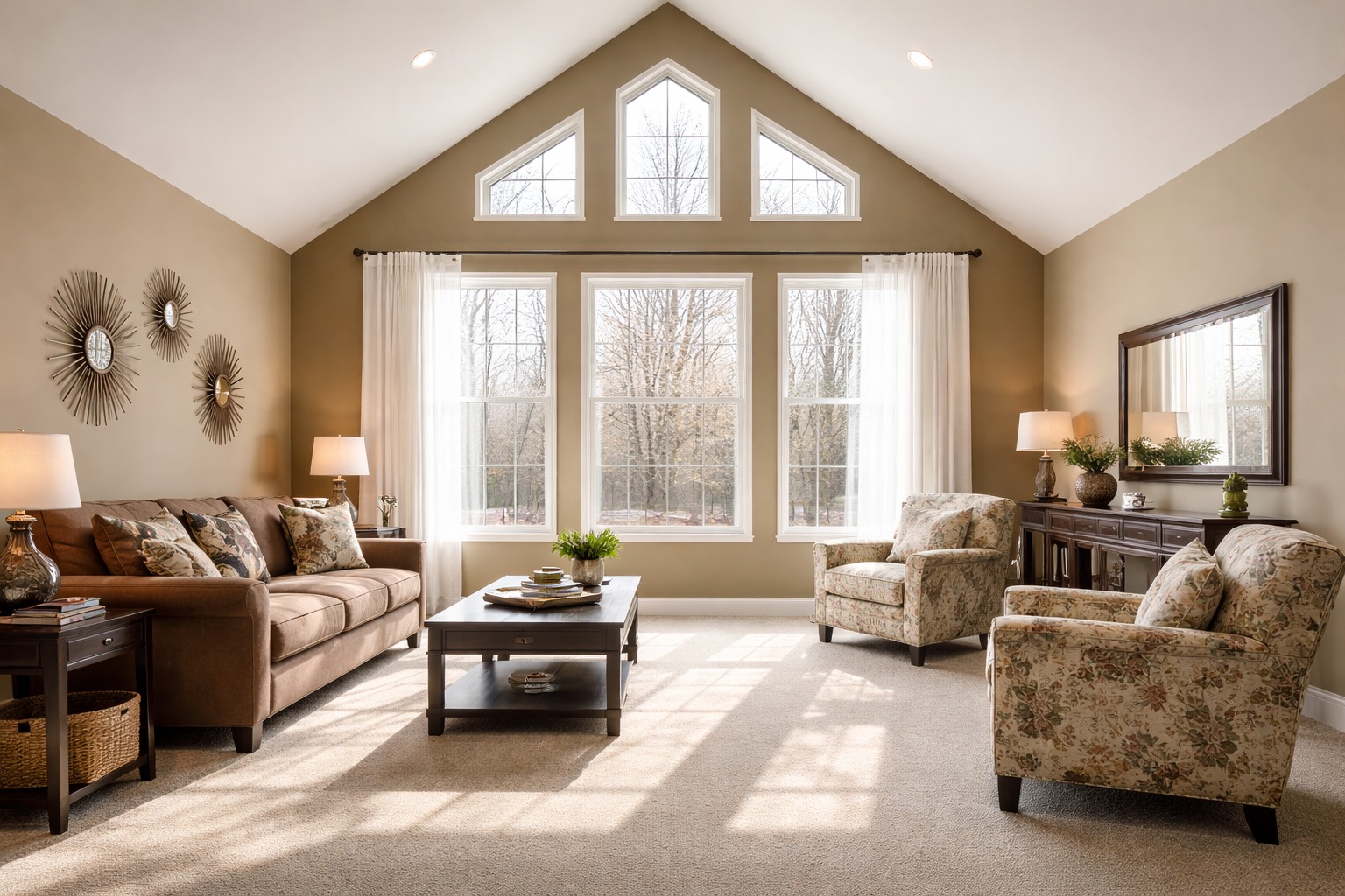 Warm, inviting living room with a large, triangular window showcasing a wintery scene. Brown sofa, floral armchairs, coffee table, and decor create a cozy feel.