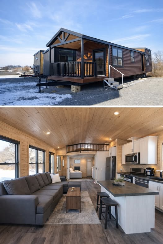 Alt text: "A modern tiny house with a dark exterior and front porch sits on a snowy landscape. Inside, a cozy living area features a gray couch, a small kitchen with white cabinets, and an open loft, exuding warmth and minimalist elegance."