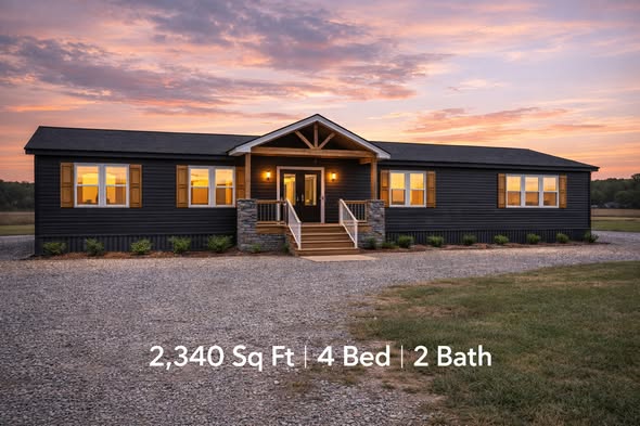 Single-story modern house with dark exterior, warm lit windows, under a vibrant sunset sky. Features include 2,340 sq ft, 4 beds, 2 baths, gravel driveway.
